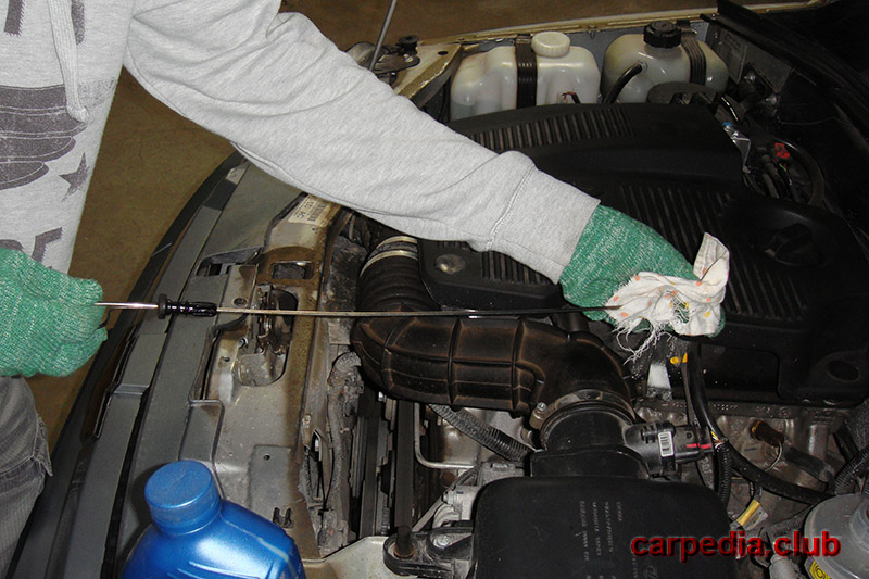 Протирание ветошью масляного щупа двигателя Chevrolet Niva