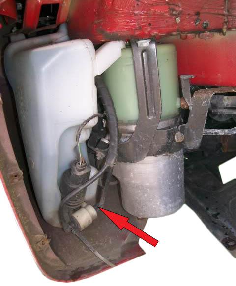 Отсоединение шлангов от насоса бачка омывателя автомобиля Skoda Fabia I