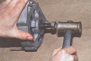 Молотком с наконечником из мягкого металла выбиваем вал ротора из переднего подшипника генератора ГАЗ 31105 Волга