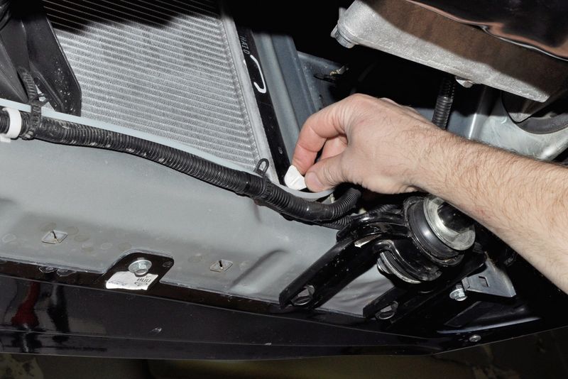 Откручивание пробки сливного отверстия радиатора двигателя Лада Гранта (ВАЗ 2190)