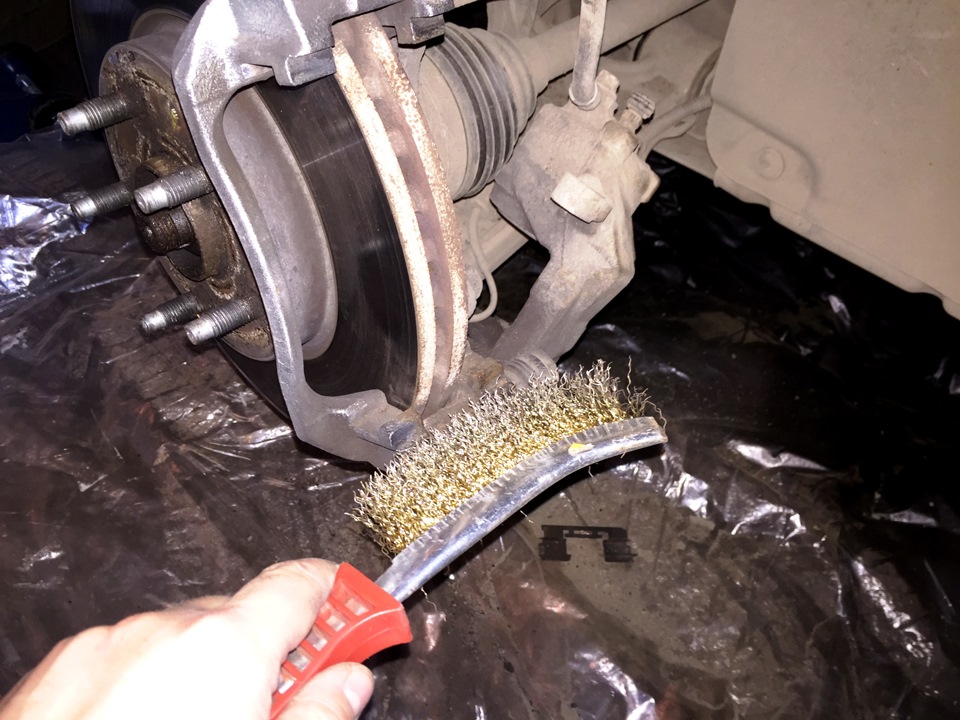 Очистить от грязи места переднего суппорта на автомобиле Chevrolet Cruze J300 2008-2016