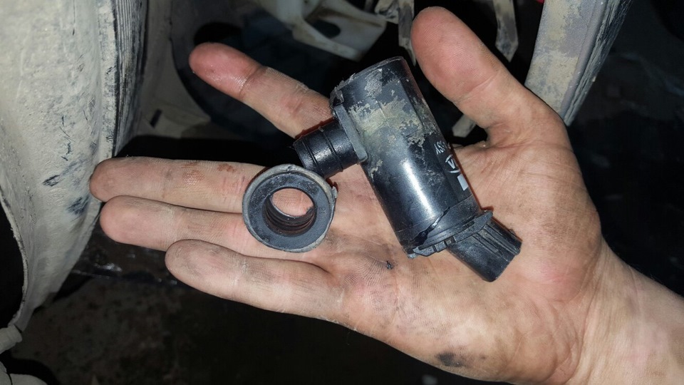 Remove the windshield washer pump on a Hyundai Solaris