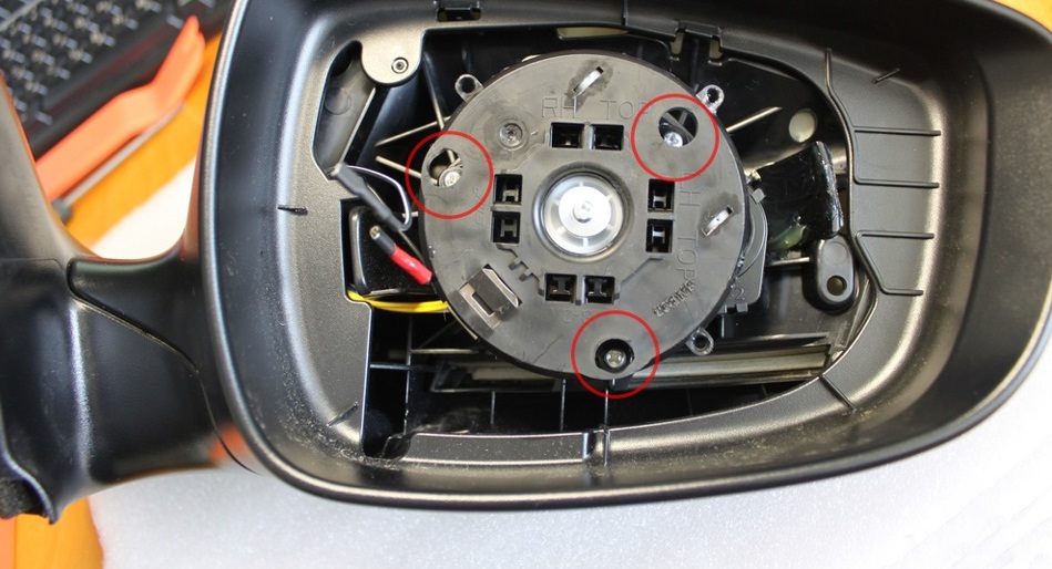 Отвернуть три самореза крепления блока мотор-редуктора к корпусу зеркала на автомобиле Hyundai Solaris