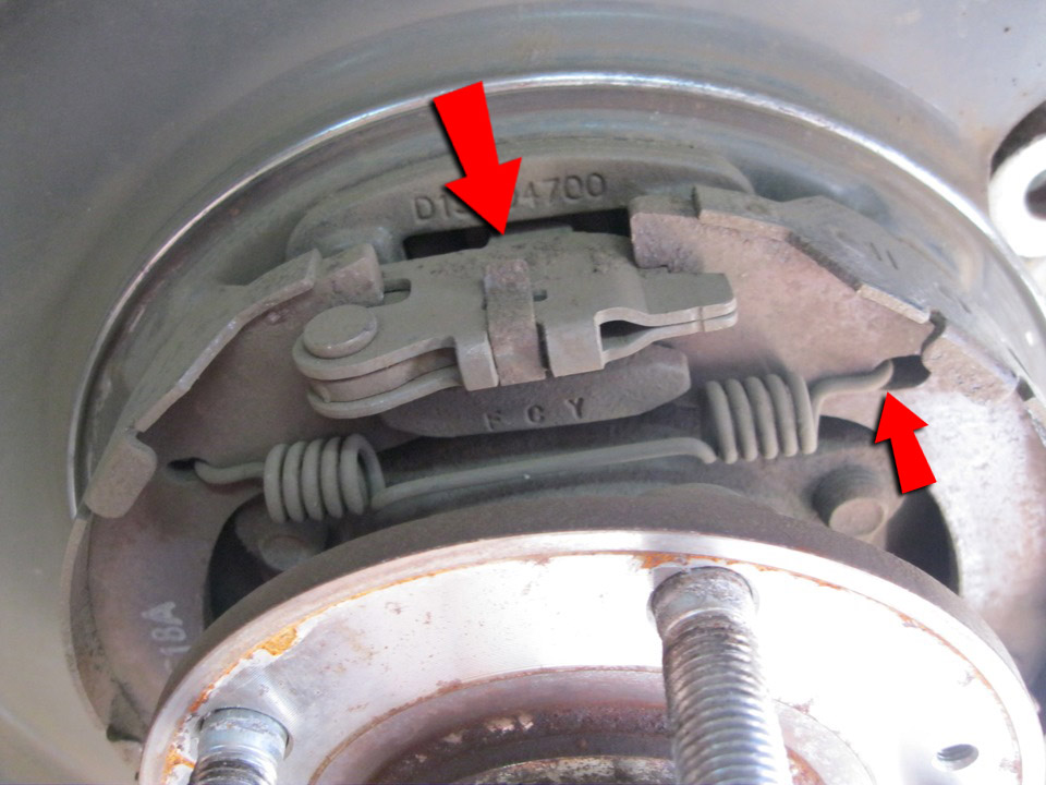 Снять верхнюю пружину колодок стояночного тормоза на автомобиле Hyundai Santa Fe CM 2006-2012