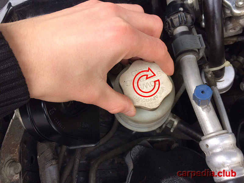 Закрутить крышку бачка гидроусилителя руля на автомобиле Mitsubishi Galant IX